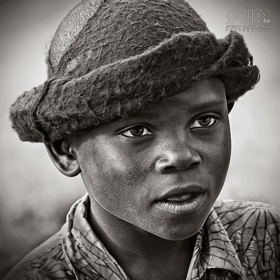 Queen Elizabeth - Katwe - Boy with hat Katwe is a small village in the national park where the people live mainly from salt mining in one of the crater lakes. We are welcomed by the many children. Stefan Cruysberghs